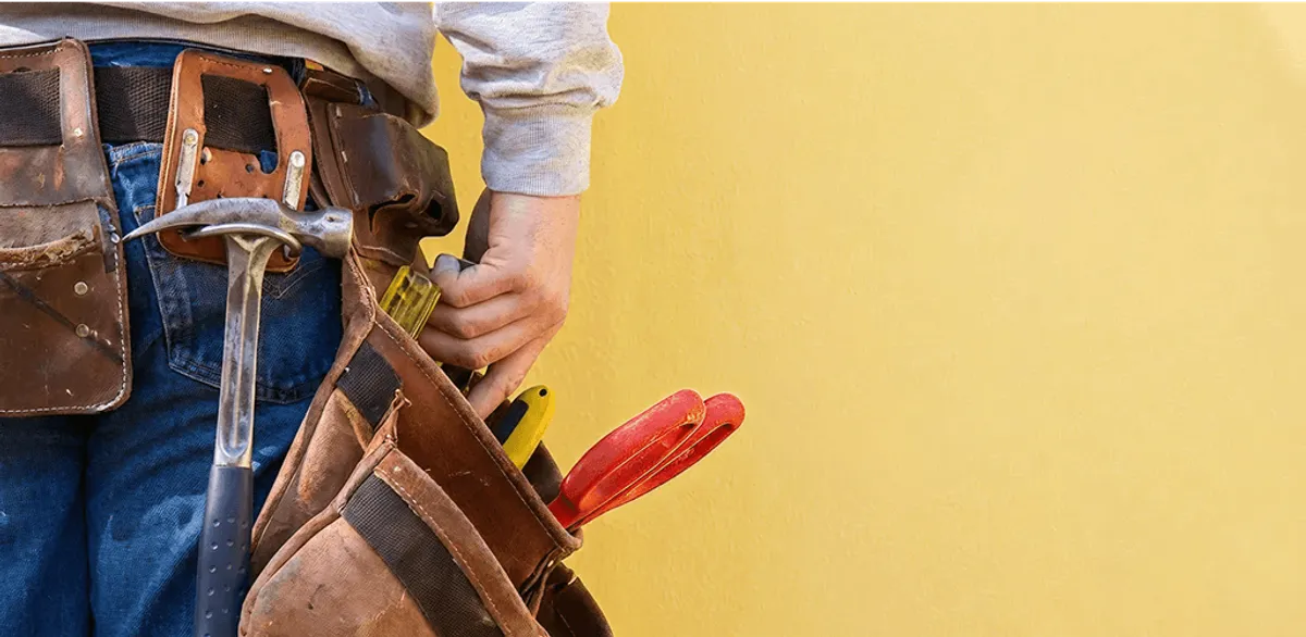 Handyman with tool belt ready for home repairs and maintenance in Baton Rouge, LA