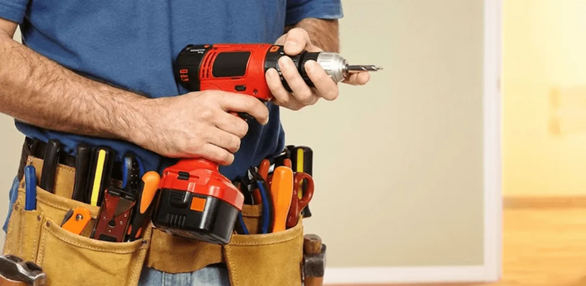 Handyman holding a power drill for home repairs and installations in Baton Rouge, LA