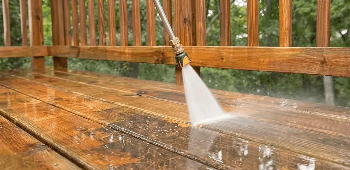 Pressure washing a wood deck to remove dirt and buildup in Baton Rouge, LA
